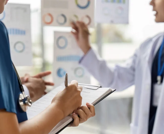 Medical professionals discussing healthcare compliance and occupational health data.